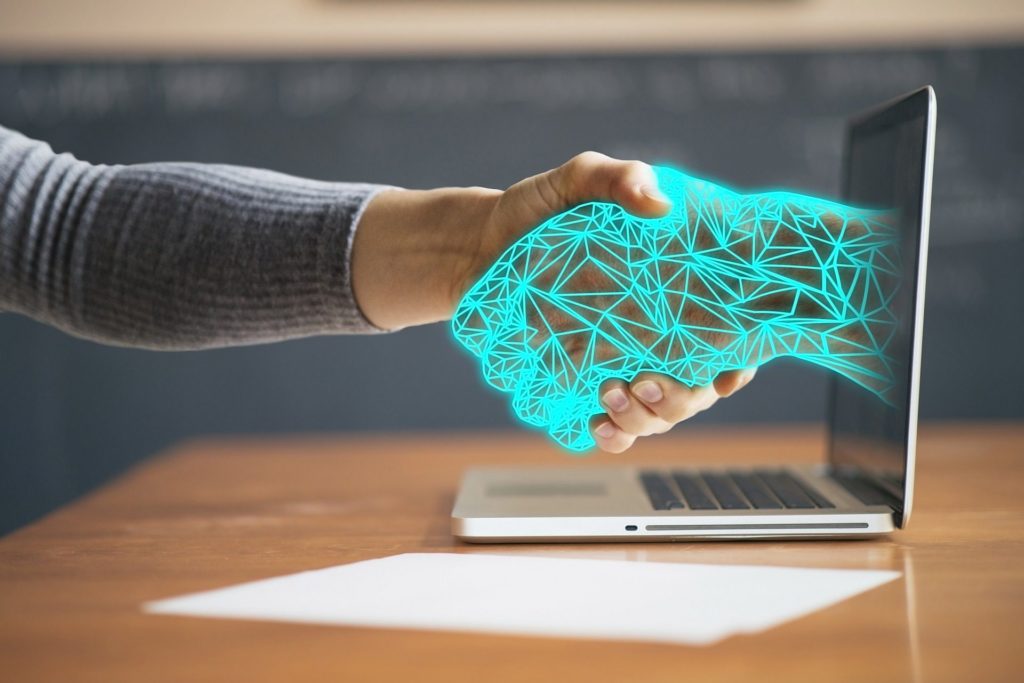 shaking hands with a virtual hand through a computer