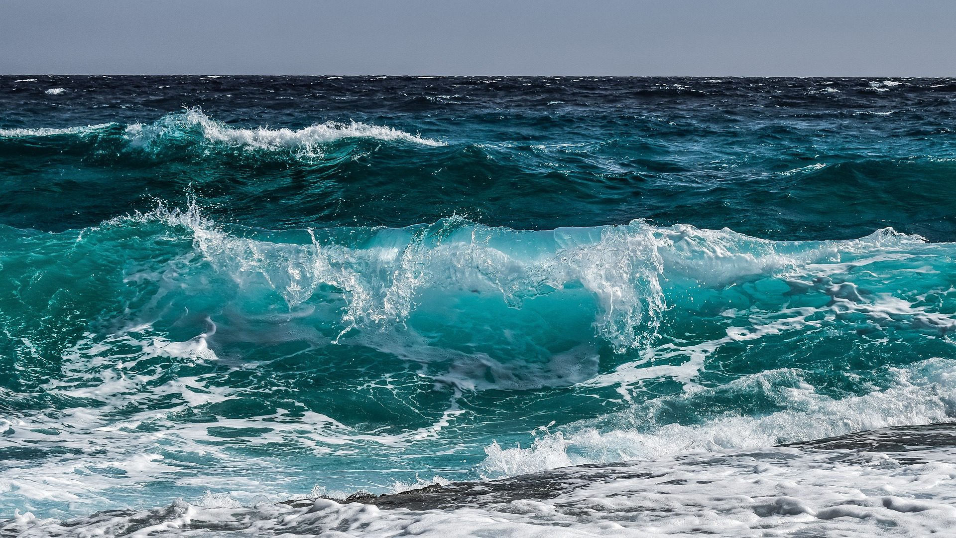 blue waves crashing on a beach